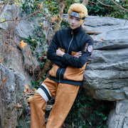 Person in a cosplay outfit standing in a natural setting with rocks and foliage.