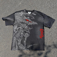 Black t-shirt with a graphic design of a creature and red text on a gray surface